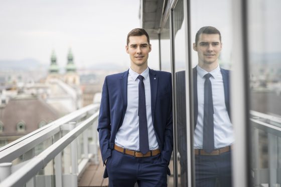 Gergely Máriás portfolio manager is standing next to a building